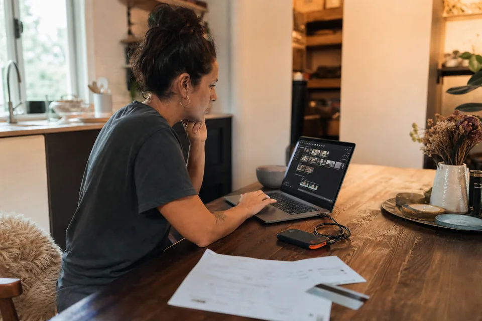 Business owner backing up finished videos to an external drive before cancelling a subscription